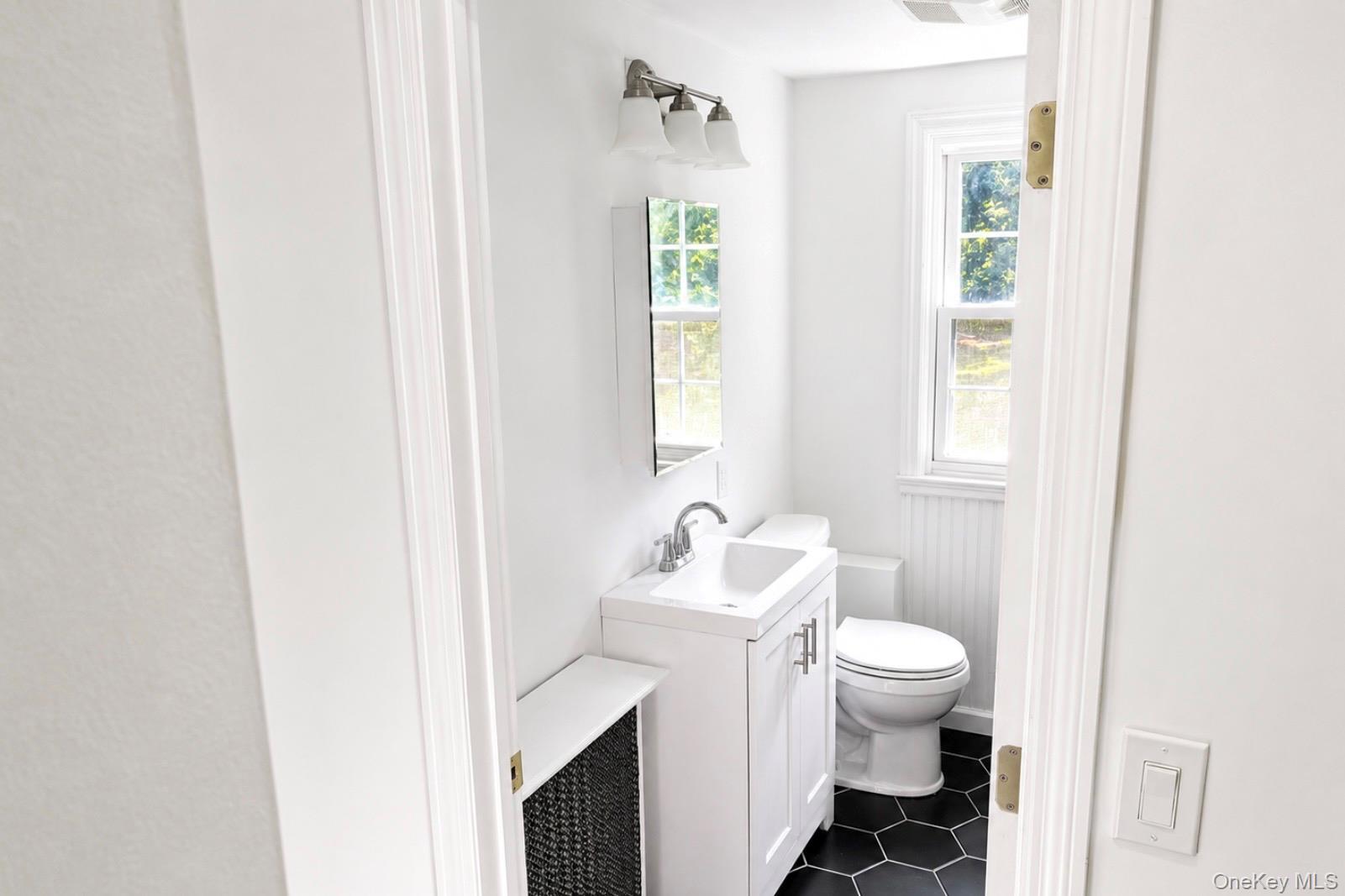 80 Mt Pleasant Road Smithtown, NY 11787 - Photo 15 of 27 a white toilet sitting next to a bathroom sink