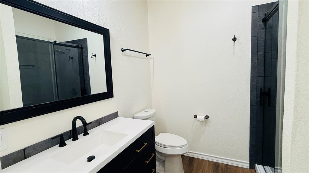 415 Colorado Avenue Graham, TX 76450 - Photo 5 of 16 a bathroom with a sink and a mirror