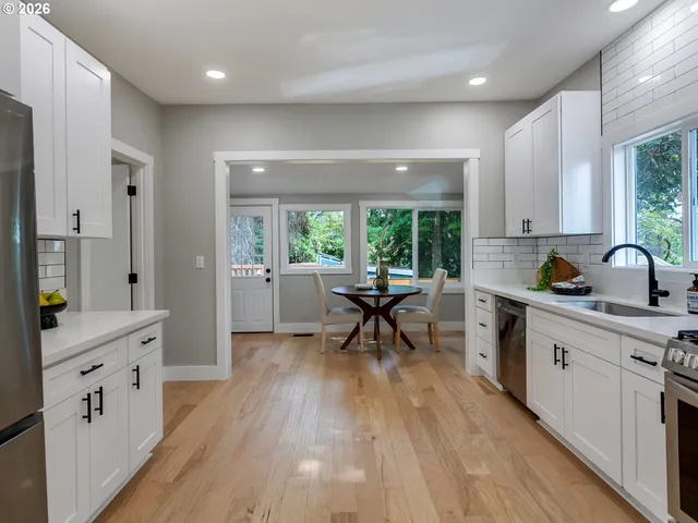 a kitchen with sink cabinets and wooden floor