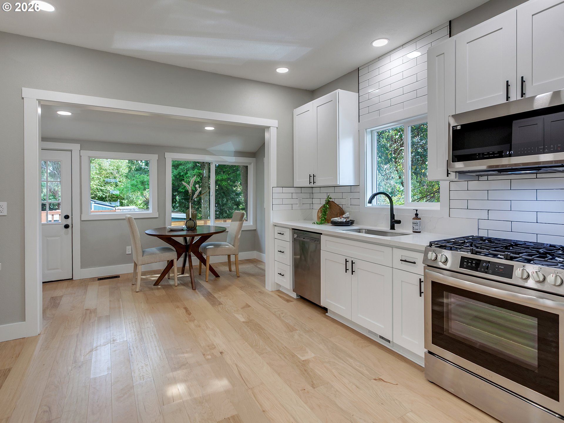 7224 Southwest 3rd Avenue Portland, OR 97219 - Photo 14 of 42 a kitchen with a stove a sink and a microwave