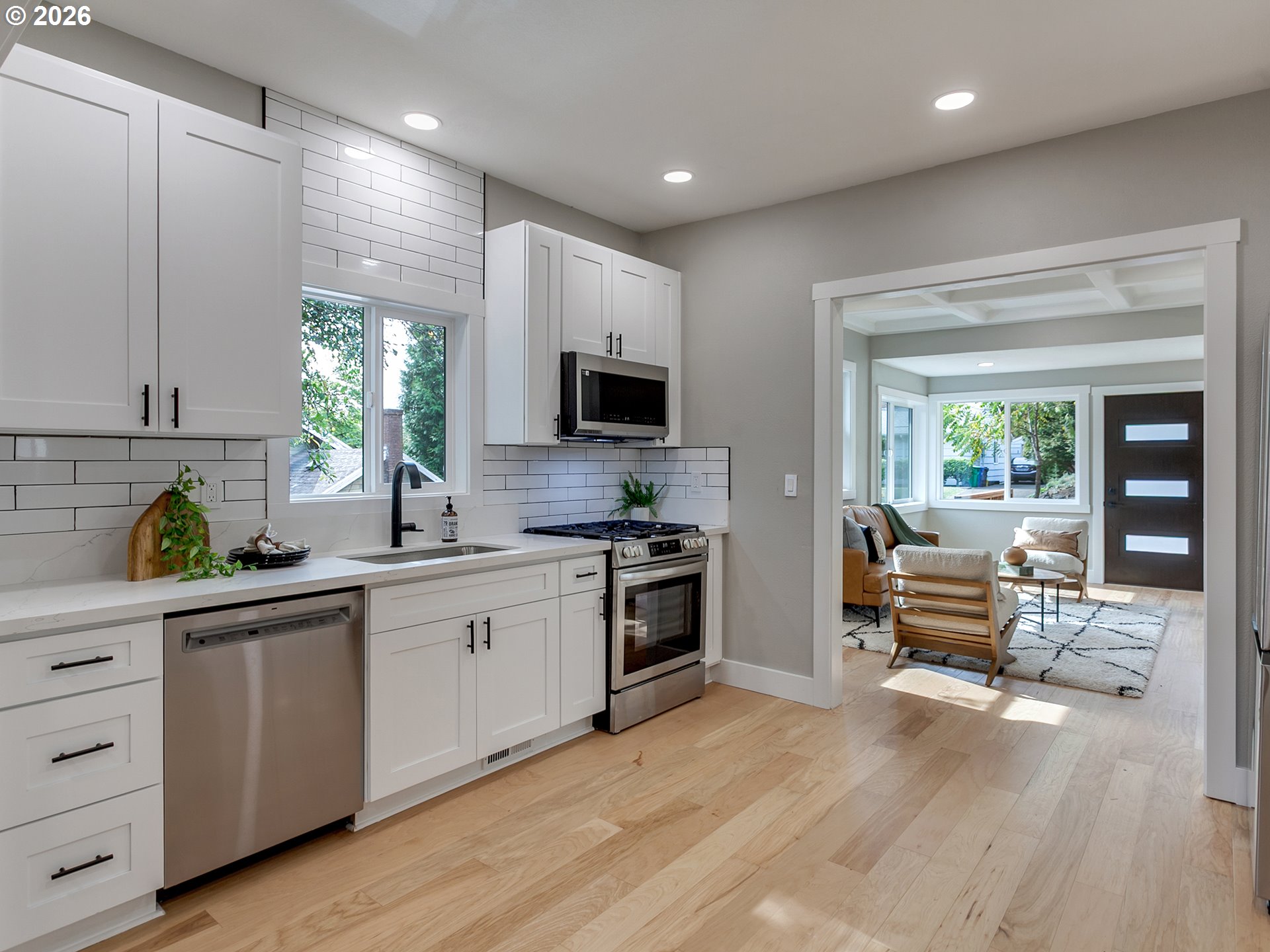 7224 Southwest 3rd Avenue Portland, OR 97219 - Photo 15 of 42 a kitchen with white cabinets and black stainless steel appliances
