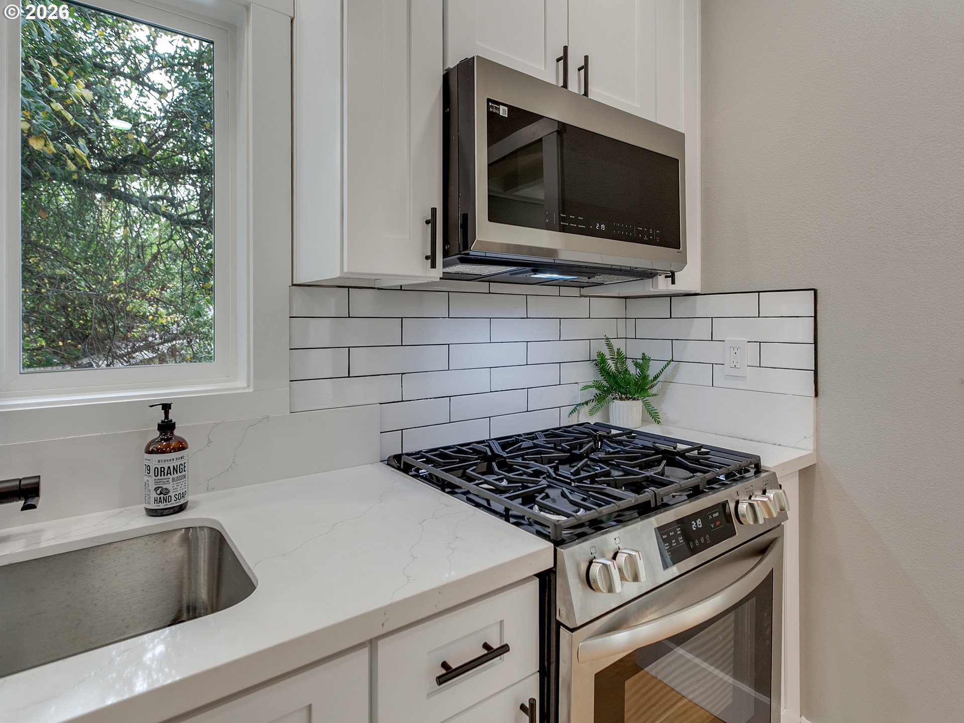7224 Southwest 3rd Avenue Portland, OR 97219 - Photo 18 of 42 a kitchen with a stove and a sink