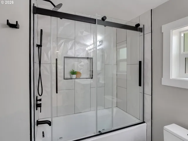 a bathroom with a glass shower door