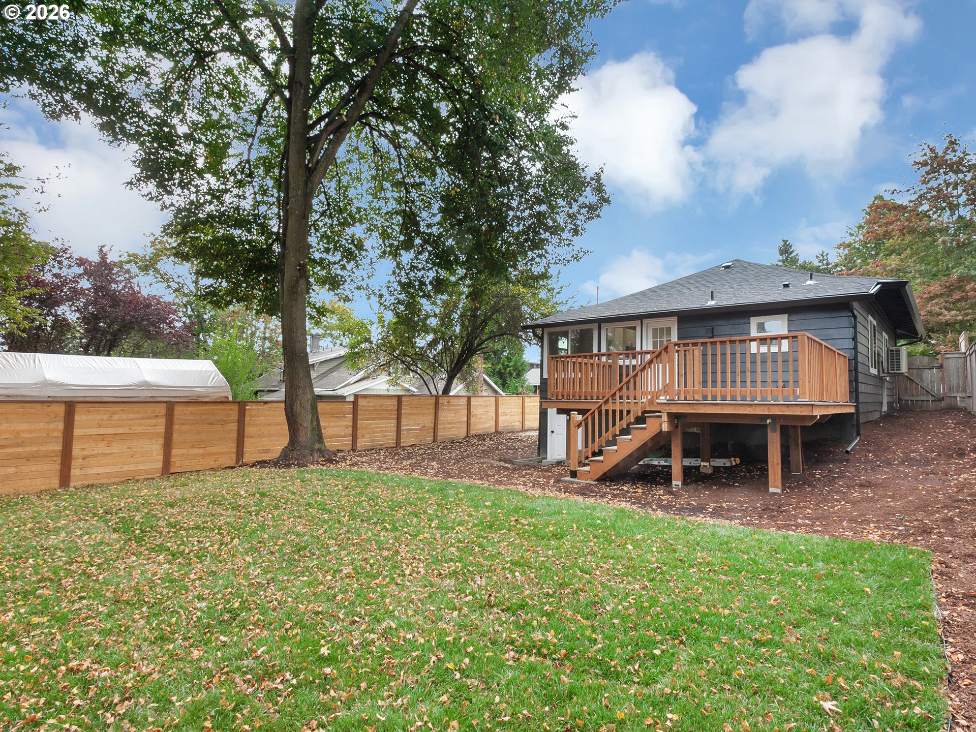 7224 Southwest 3rd Avenue Portland, OR 97219 - Photo 37 of 42 a view of a house with a yard and table under an umbrella