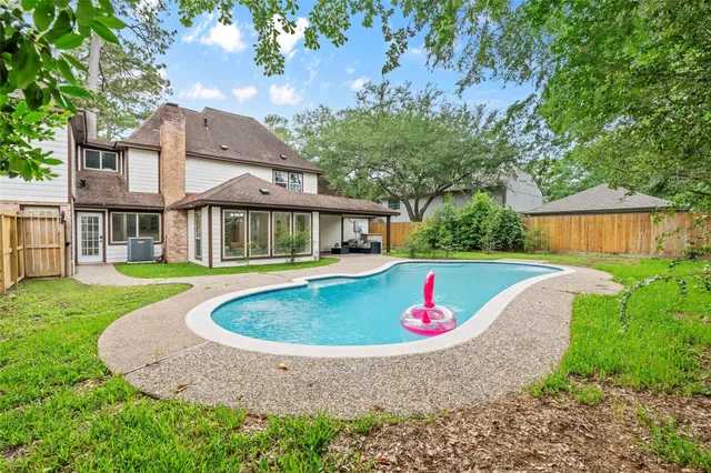 a aerial view of a house with swimming pool and porch