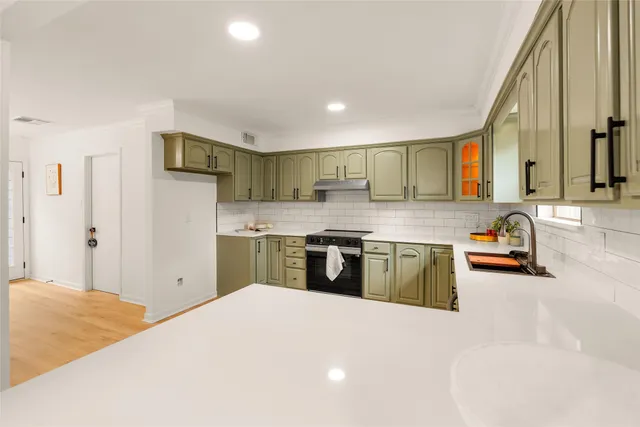 a kitchen with stainless steel appliances granite countertop a sink and stove