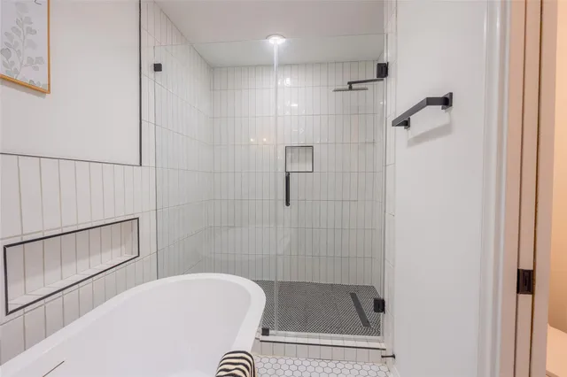 a bathroom with a tub and shower