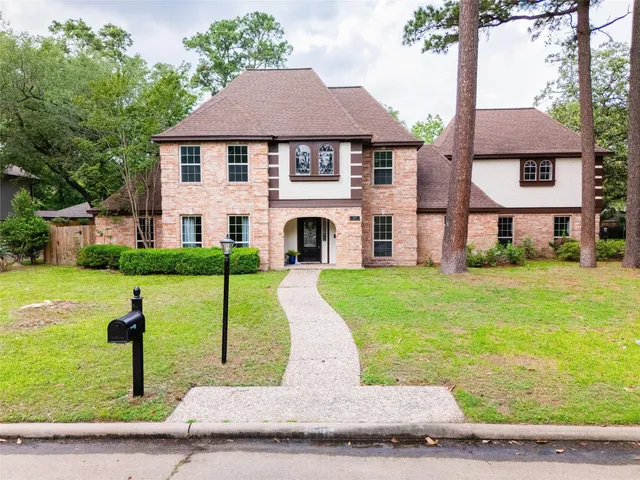 a view of a white house with a yard and plants