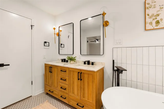 a bathroom with a double vanity sink and mirror