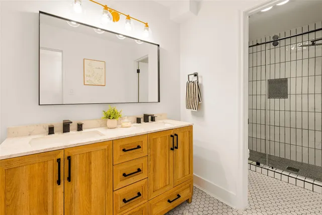 a bathroom with a sink double vanity and a shower