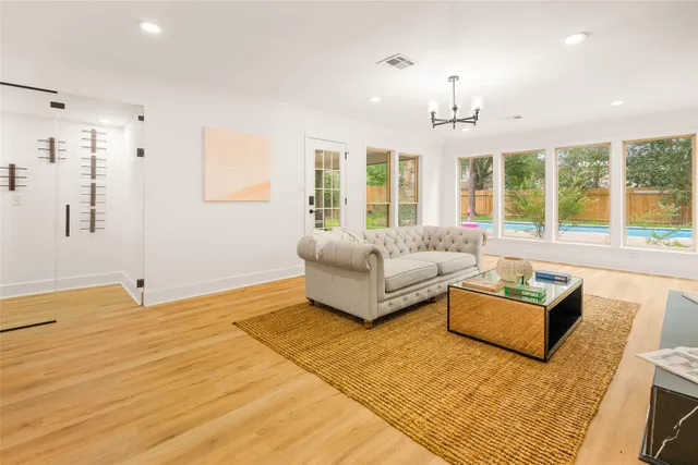 a living room with furniture and large windows