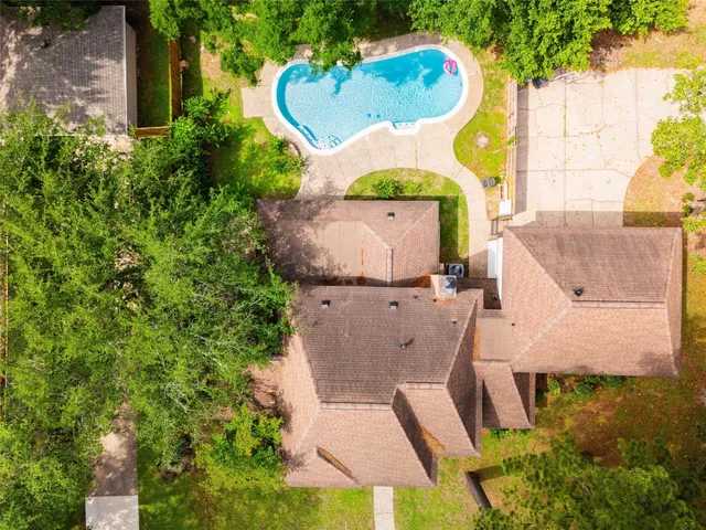 an aerial view of a house with a swimming pool