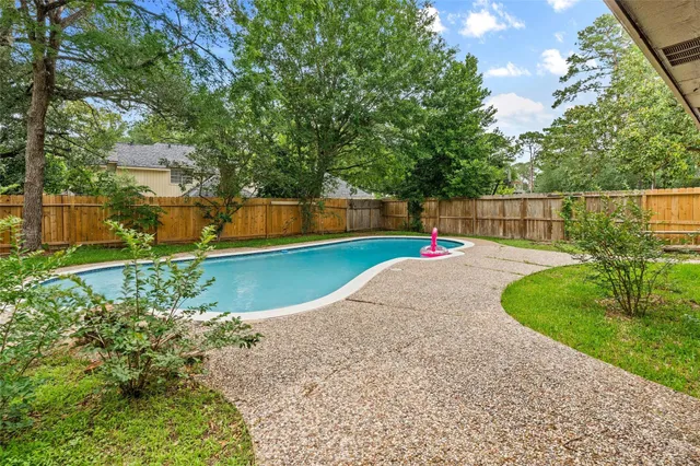 a childrens park with lots of green space and trees