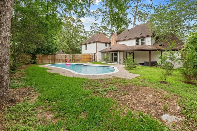 a view of a house with a yard and sitting area