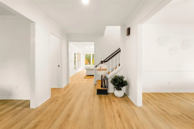 a view of a living room with wooden floor and stairs