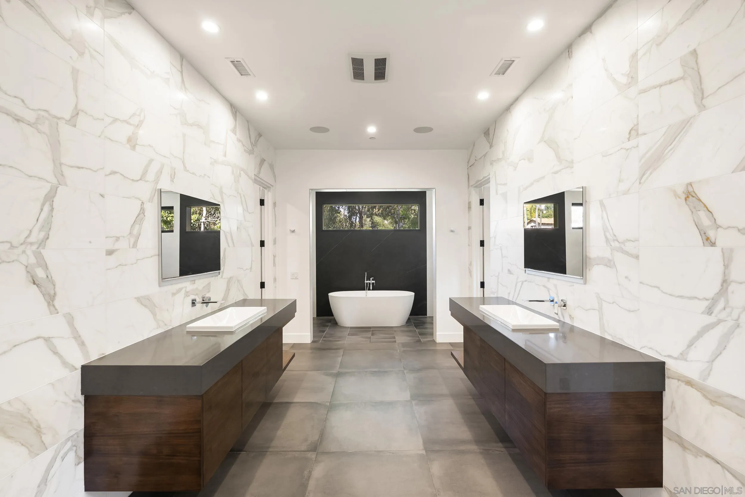 6850 Avenida De La Ronda Rancho Santa Fe, CA 92067 - Photo 21 of 40 a spacious bathroom with a double vanity sink a large mirror and bathtub