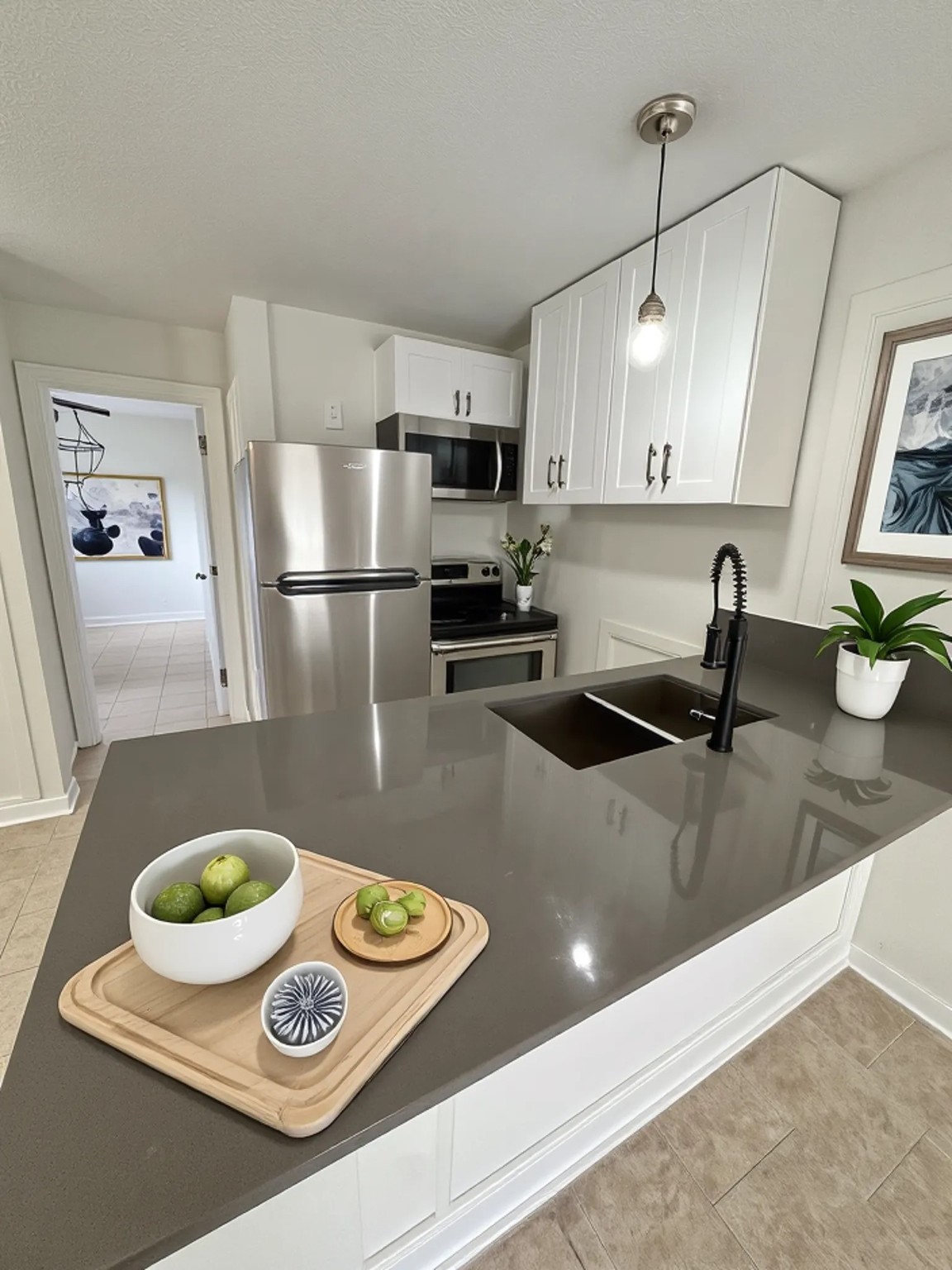 a kitchen with kitchen island stainless steel appliances a sink a stove and a refrigerator