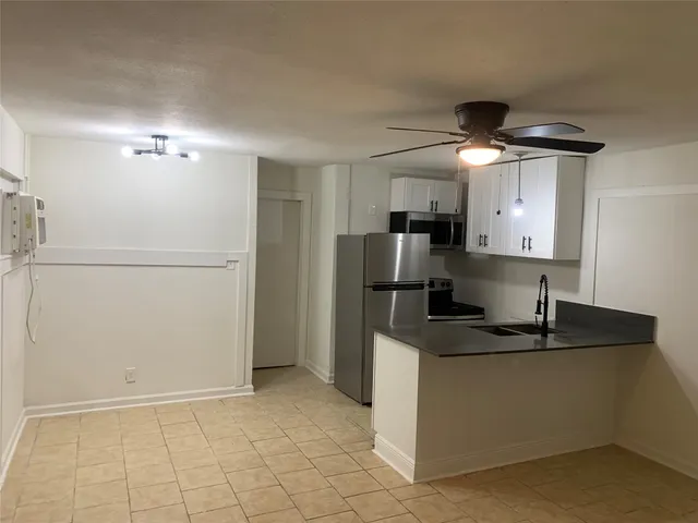 a view of a yard with a large tree