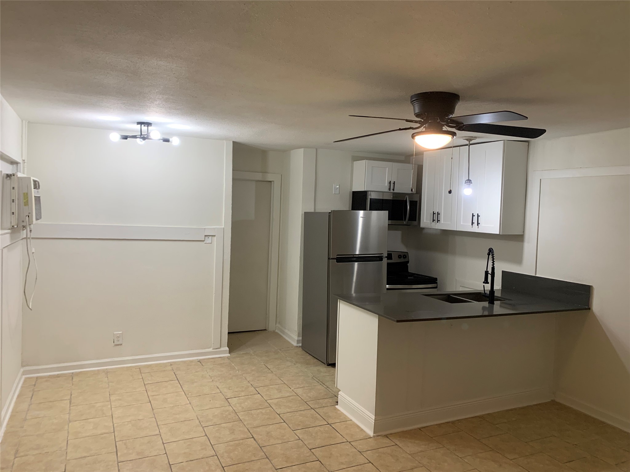 7610 Red Robin Lane, Unit 2 Houston, TX 77075 - Photo 8 of 16 a kitchen with stainless steel appliances granite countertop a refrigerator a sink and a stove