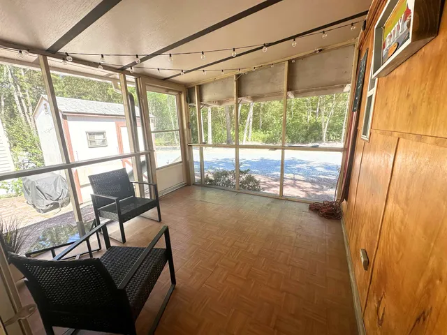 a view of a room with furniture and a window