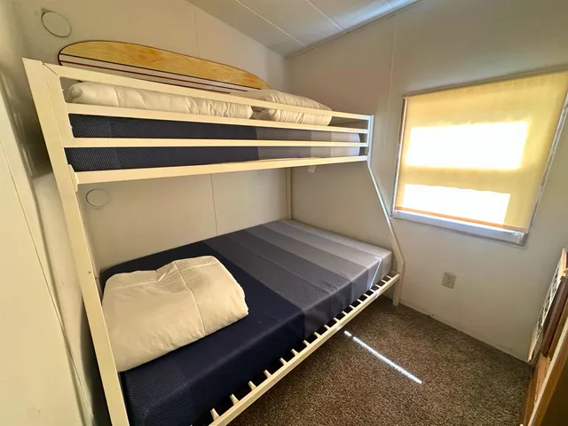 a view of a room with wooden floor and windows