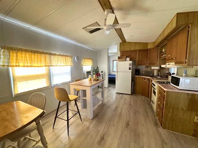 a kitchen with sink cabinets and wooden floor