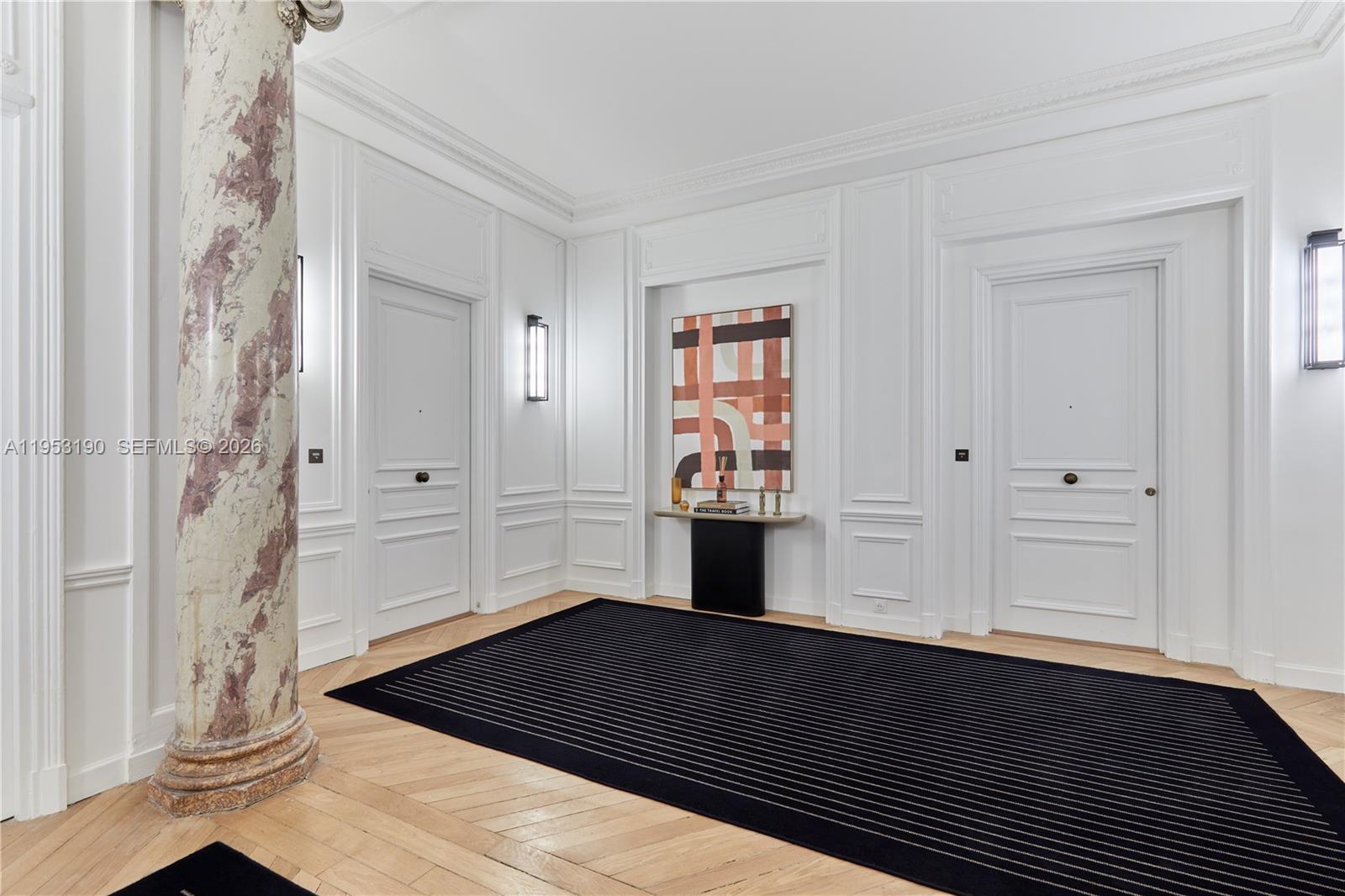 a view of an empty room and wooden floor