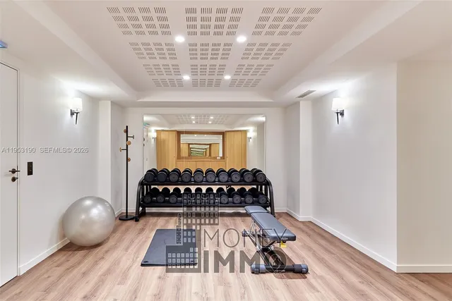 a bedroom with a large bed and wooden floor