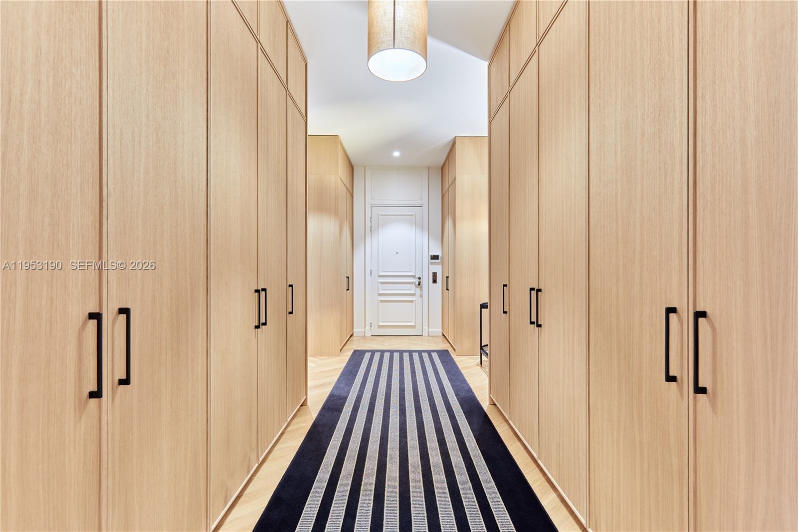 11 Rue Saint-Dominique, Unit SDO 403 Carrollton, IDF 75007 - Photo 12 of 40 a view of a hallway with wooden floor and staircase