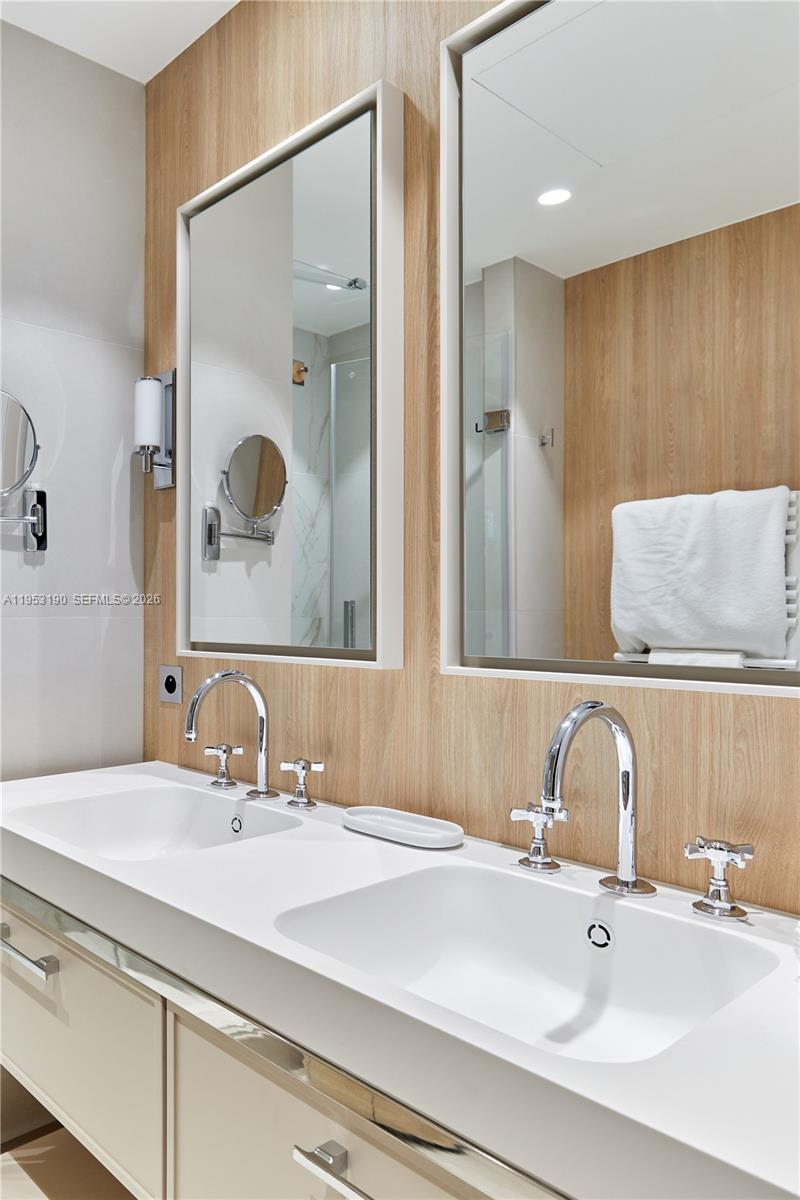 11 Rue Saint-Dominique, Unit SDO 403 Carrollton, IDF 75007 - Photo 14 of 40 a bathroom with a sink and a mirror