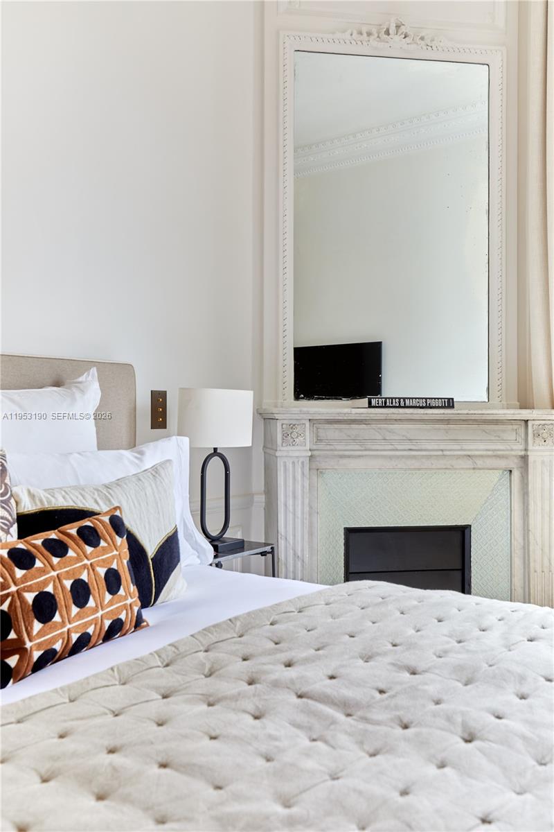 11 Rue Saint-Dominique, Unit SDO 403 Carrollton, IDF 75007 - Photo 15 of 40 a bedroom with a bed and a fireplace