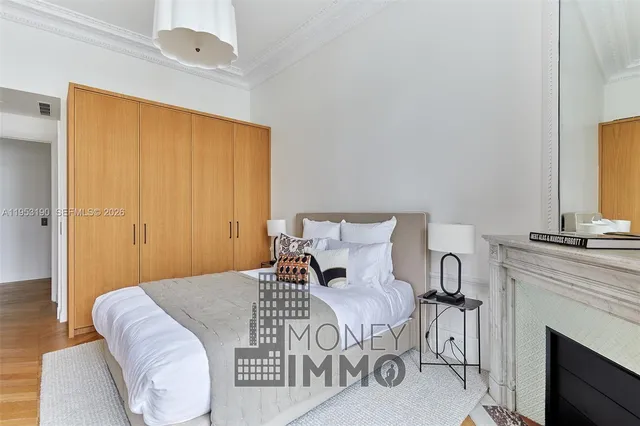 a bedroom with a bed and a fireplace