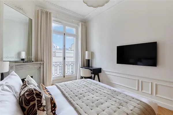 a bedroom with a bed and a flat screen tv
