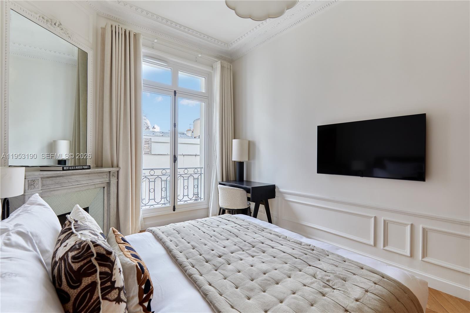 11 Rue Saint-Dominique, Unit SDO 403 Carrollton, IDF 75007 - Photo 19 of 40 a bedroom with a bed and a flat screen tv