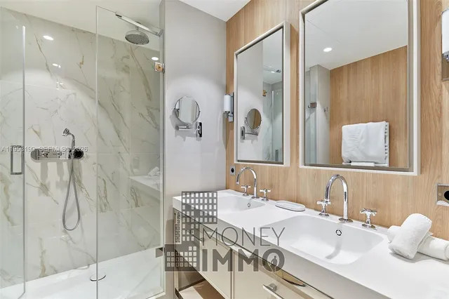 a bathroom with a sink shower and a mirror