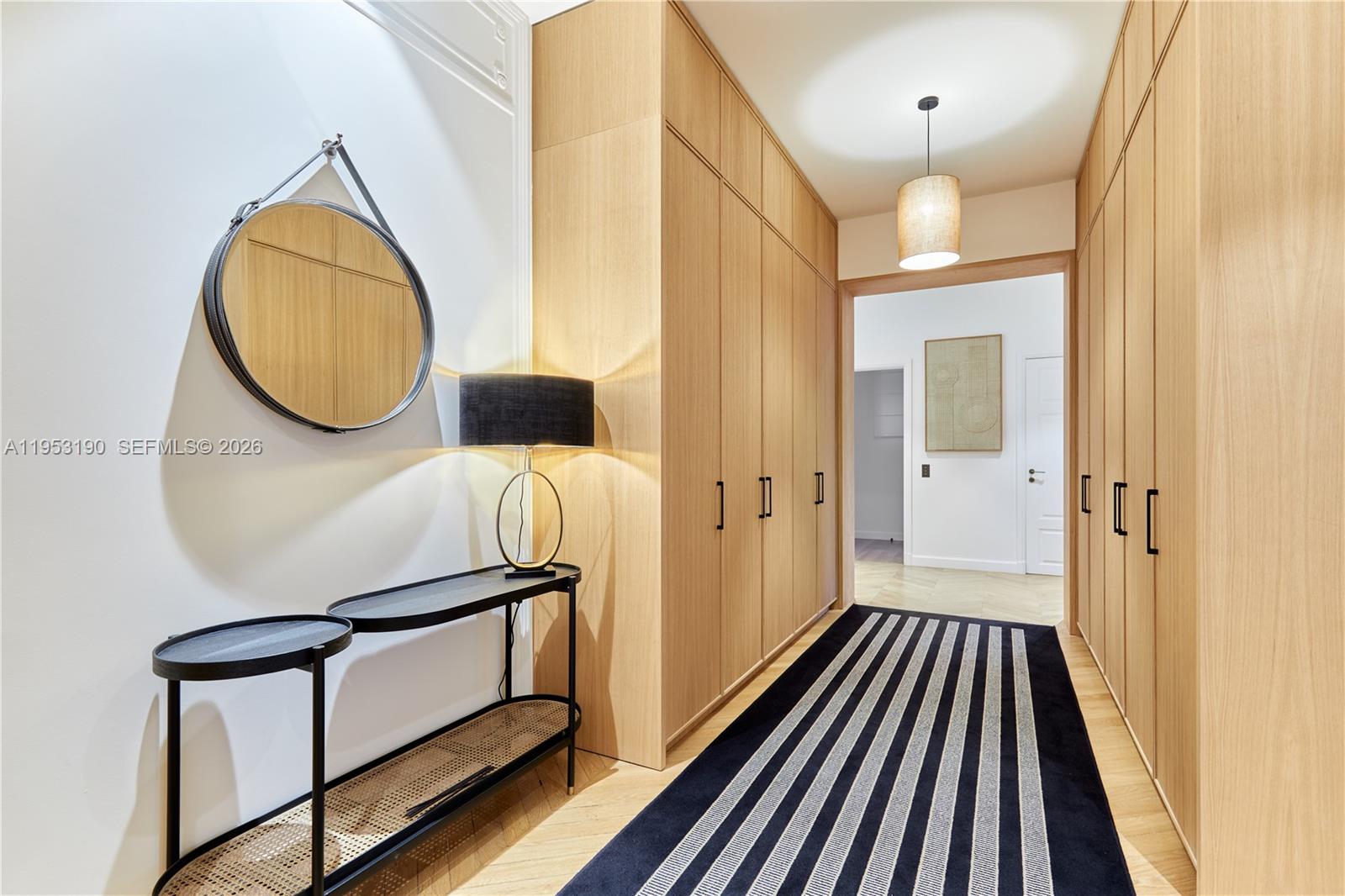 11 Rue Saint-Dominique, Unit SDO 403 Carrollton, IDF 75007 - Photo 3 of 40 a view of a hallway with wooden floor and staircase