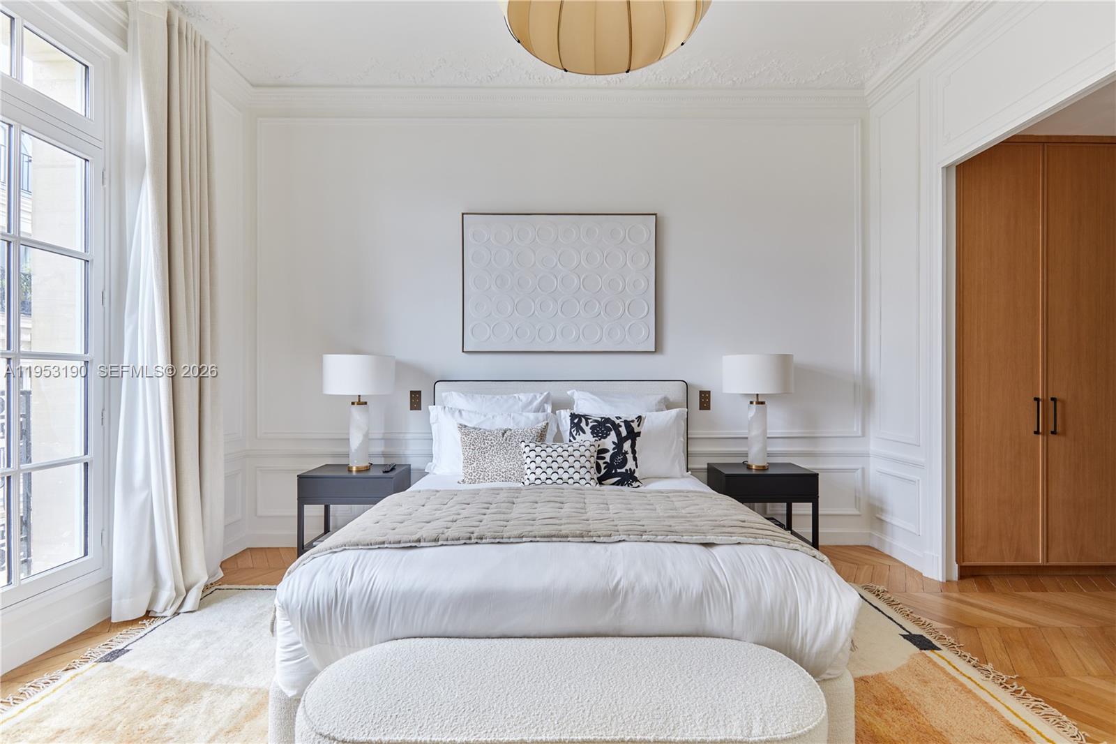 11 Rue Saint-Dominique, Unit SDO 403 Carrollton, IDF 75007 - Photo 35 of 40 a bedroom with bed and a window