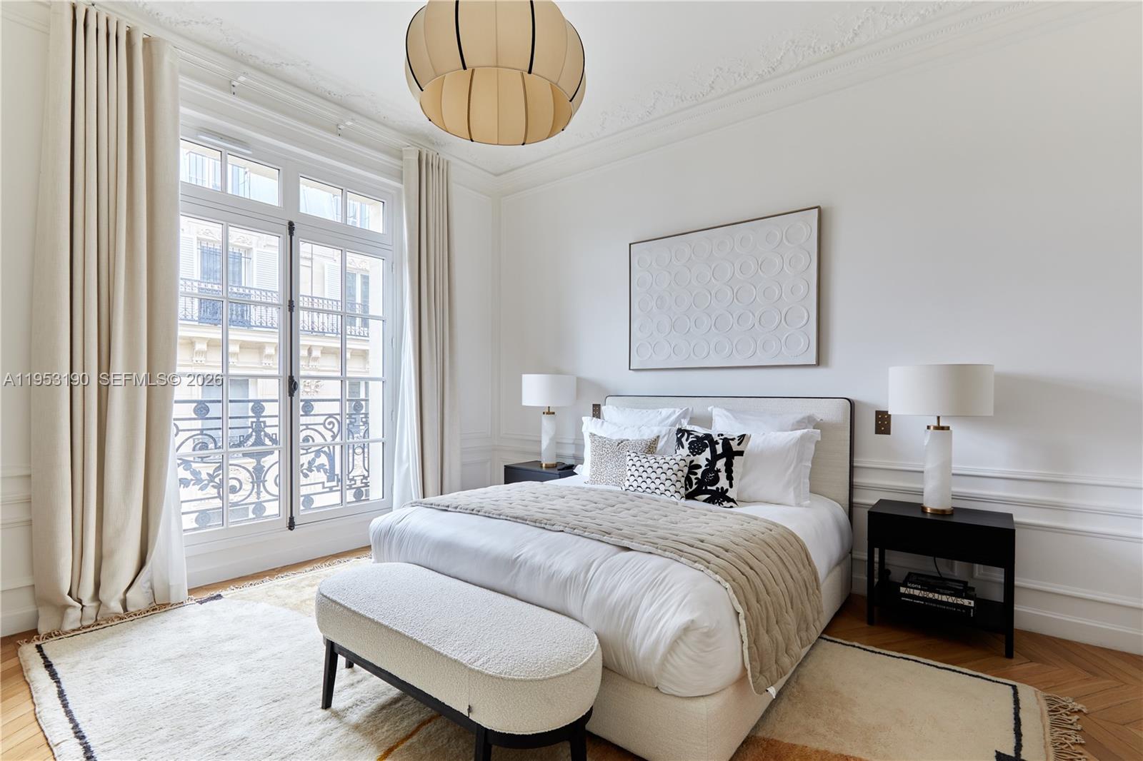 11 Rue Saint-Dominique, Unit SDO 403 Carrollton, IDF 75007 - Photo 36 of 40 a bedroom with a bed and wooden floor