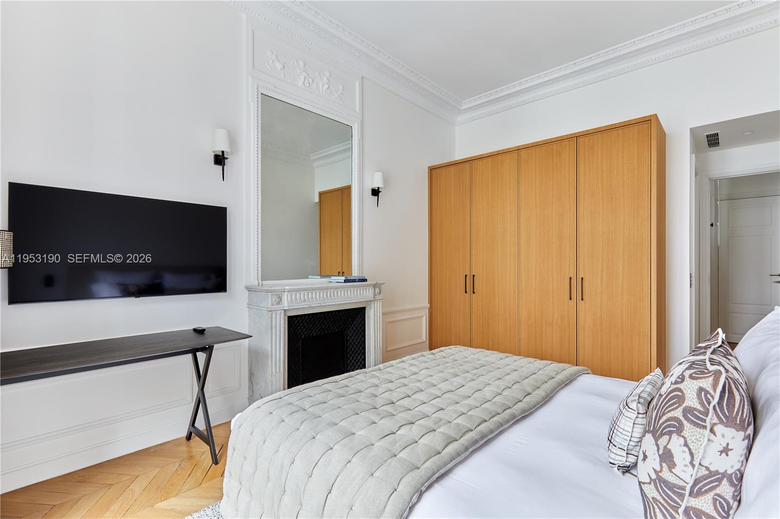 11 Rue Saint-Dominique, Unit SDO 403 Carrollton, IDF 75007 - Photo 4 of 40 a bedroom with a bed and a flat screen tv