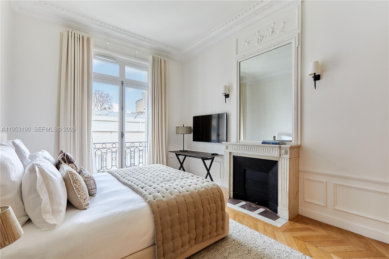 11 Rue Saint-Dominique, Unit SDO 403 Carrollton, IDF 75007 - Photo 9 of 40 a bedroom with a bed and a flat screen tv