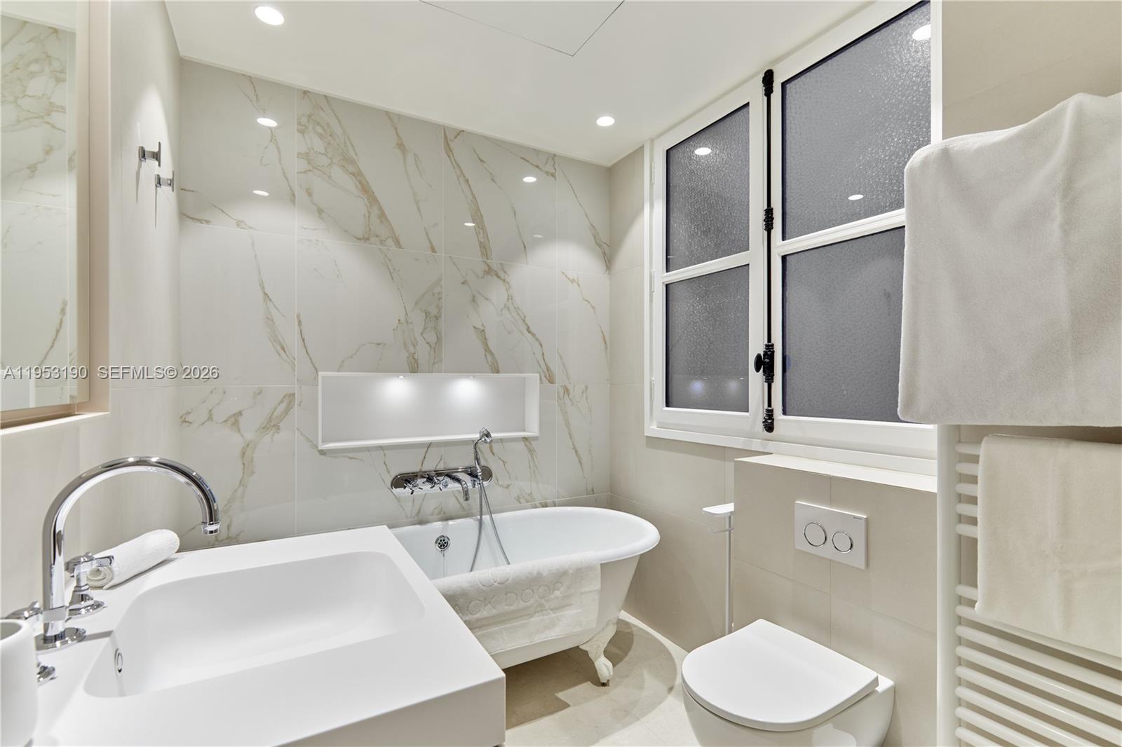 11 Rue Saint-Dominique, Unit SDO 403 Carrollton, IDF 75007 - Photo 10 of 40 a bathroom with a sink a toilet and a mirror