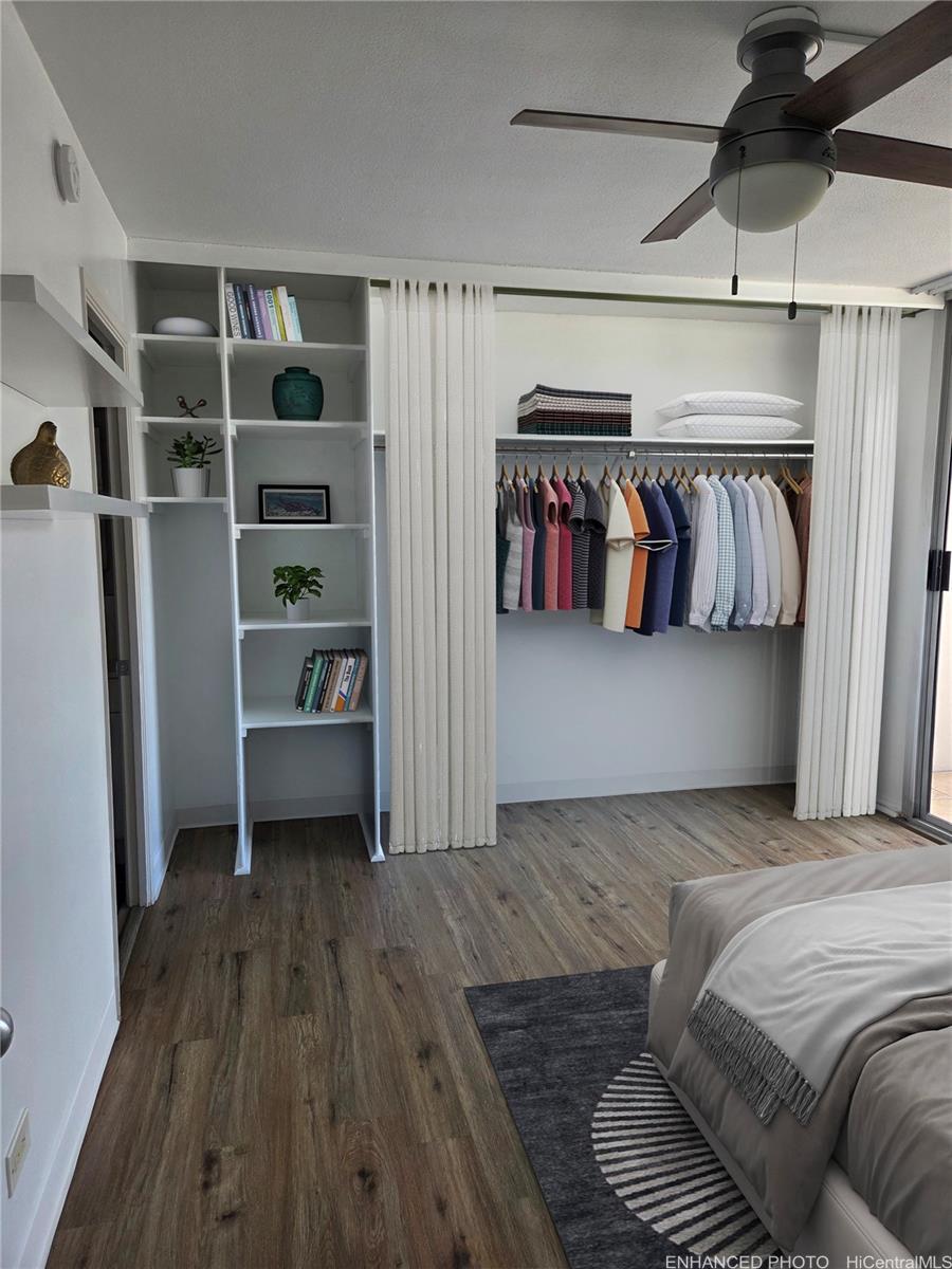 775 Kinalau Place, Unit 1508 Honolulu, HI 96813 - Photo 11 of 23 a bedroom with a bed and a walk in closet