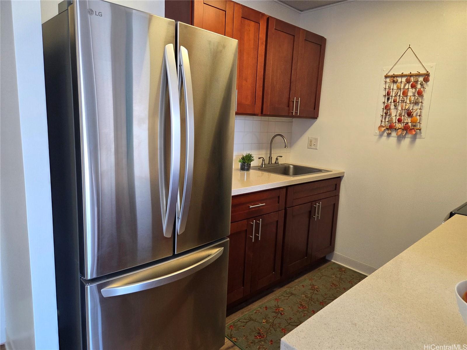 775 Kinalau Place, Unit 1508 Honolulu, HI 96813 - Photo 14 of 23 a kitchen with a refrigerator and a sink