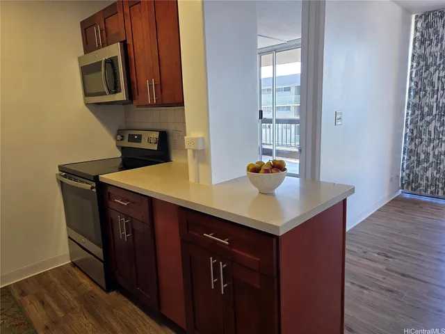 a kitchen with a sink cabinets and wooden floor