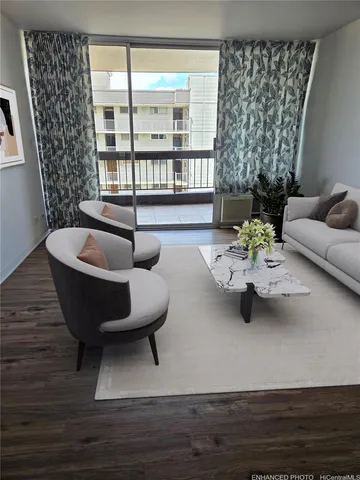 a living room with furniture and a potted plant