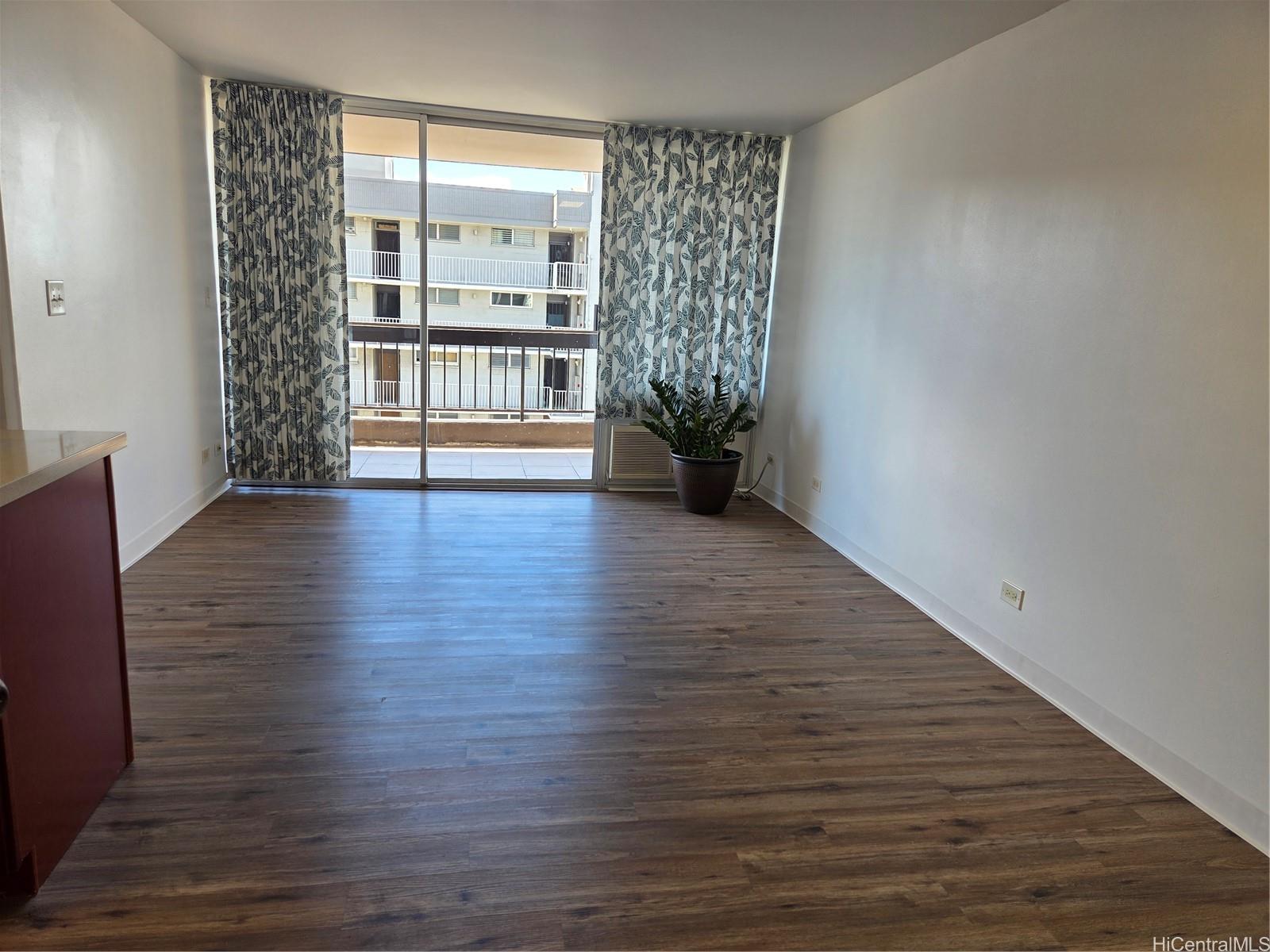 775 Kinalau Place, Unit 1508 Honolulu, HI 96813 - Photo 4 of 23 a view of an empty room with a window and wooden floor
