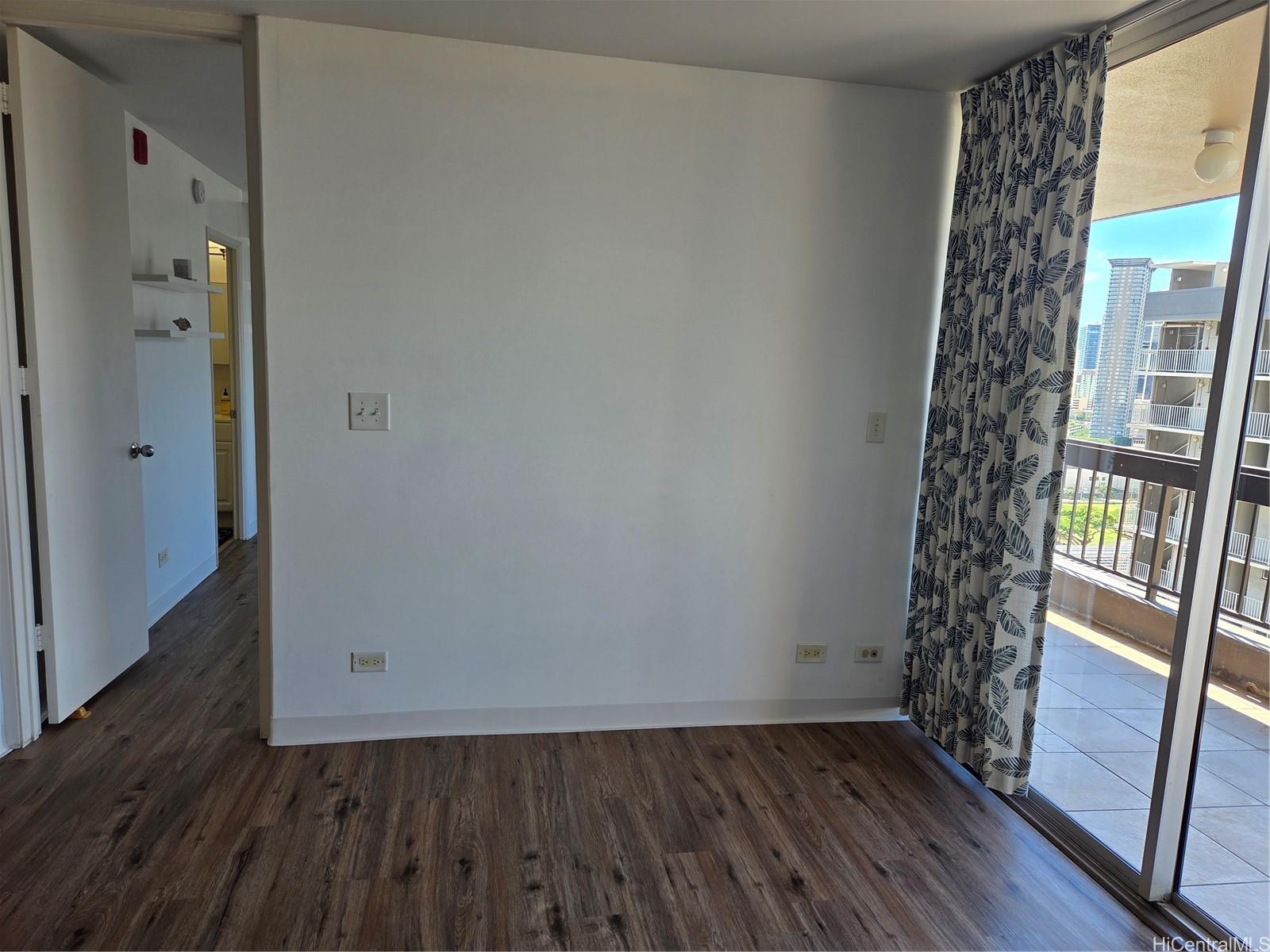 775 Kinalau Place, Unit 1508 Honolulu, HI 96813 - Photo 6 of 23 a view of an empty room with wooden floor and a window