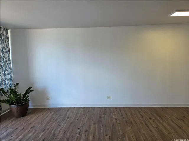 a view of a room with wooden floor and potted plants