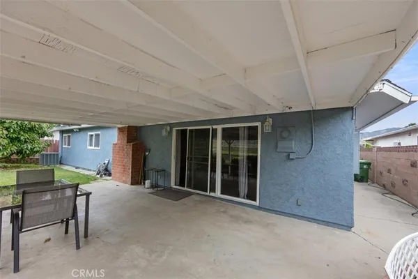 a view of an house with porch and furniture