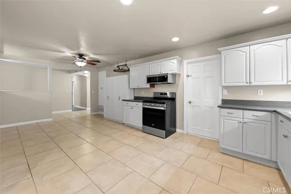 a kitchen with kitchen island white cabinets and appliances